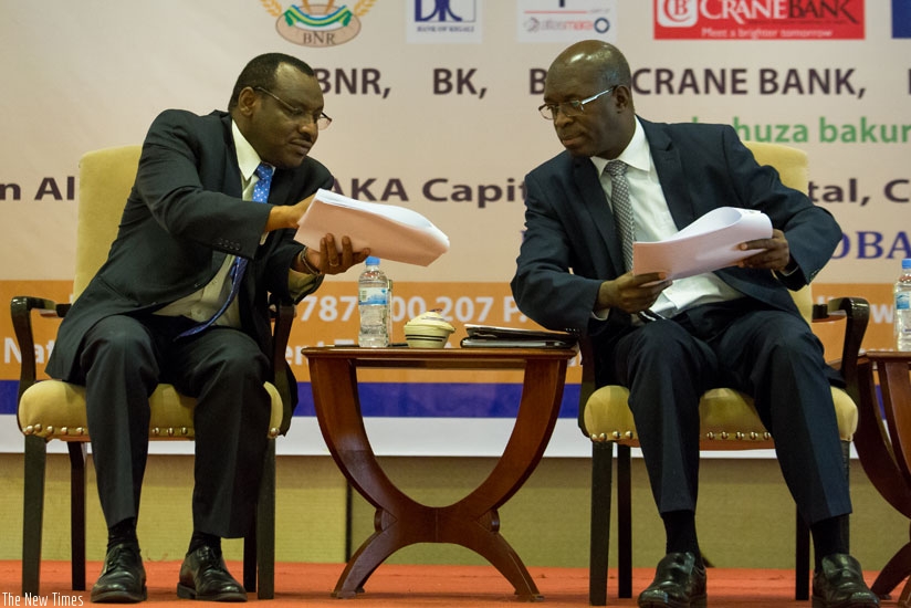Finance and Economic Planning minister Claver Gatete (L) speaks to Premier Murekezi during the launch of Iterambere Fund in Kigali yesterday. / Timothy Kisambira.