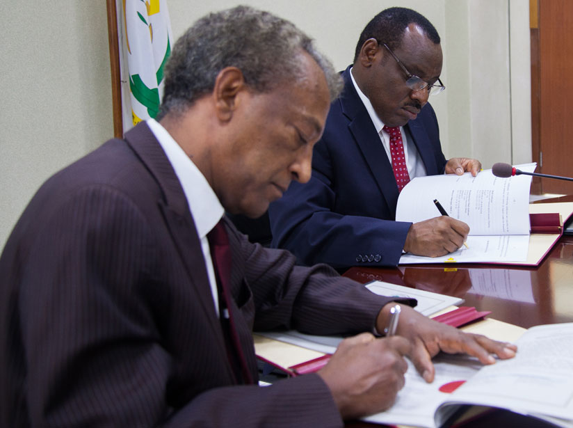 Gatete and Makonnen sign the loan agreement in Kigali yesterday. (All photos by Nadege Imbabazi)