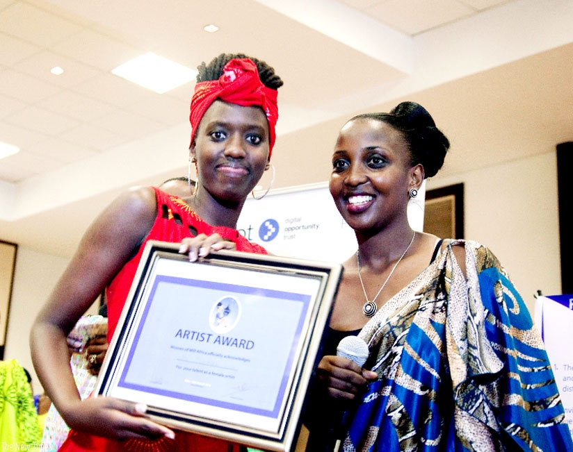 Musician Ciney (L) after being handed the Artist Award during the Rwanda Women Festival  at Kigali Serena Hotel in March last year. Right, is Mwenedata.