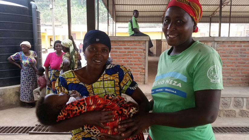 Teredia Uwihoreye shares a light moment with some of the mothers whose babies were saved through Rapid SMS