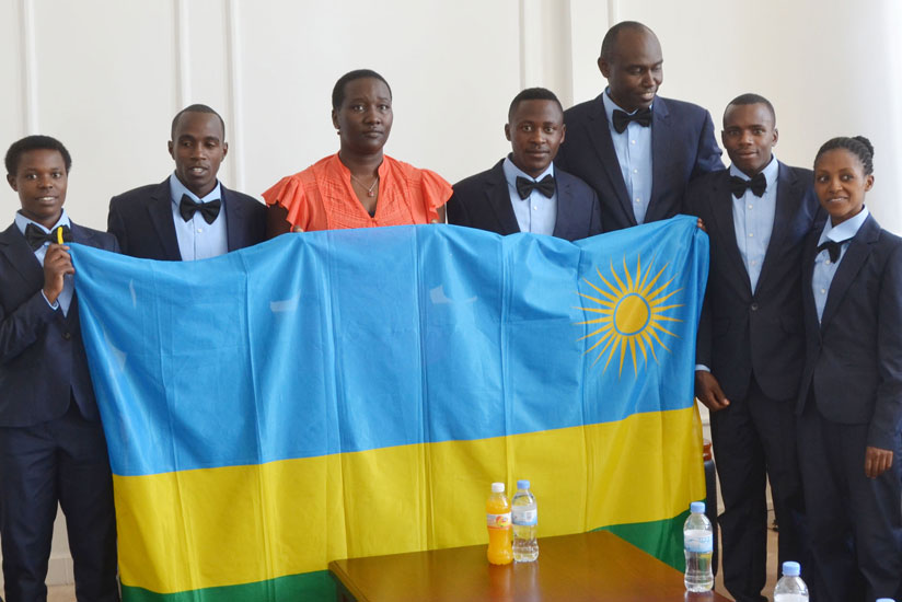 The athletics team pose for a picture with Minister Julienne Uwacu (C) in her office at Amahoro national stadium. The team leaves today for the U20 World Championships in Poland. / Sam Ngendahimana.