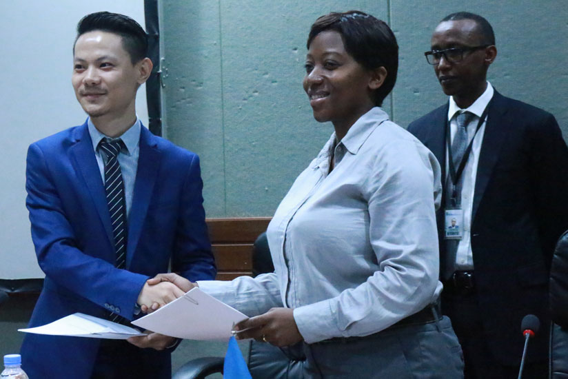 Josephine Nyiranzeyimana exchanging the signed MoU with her Chinese counterpart Liu Fei. / Julius Bizimungu.