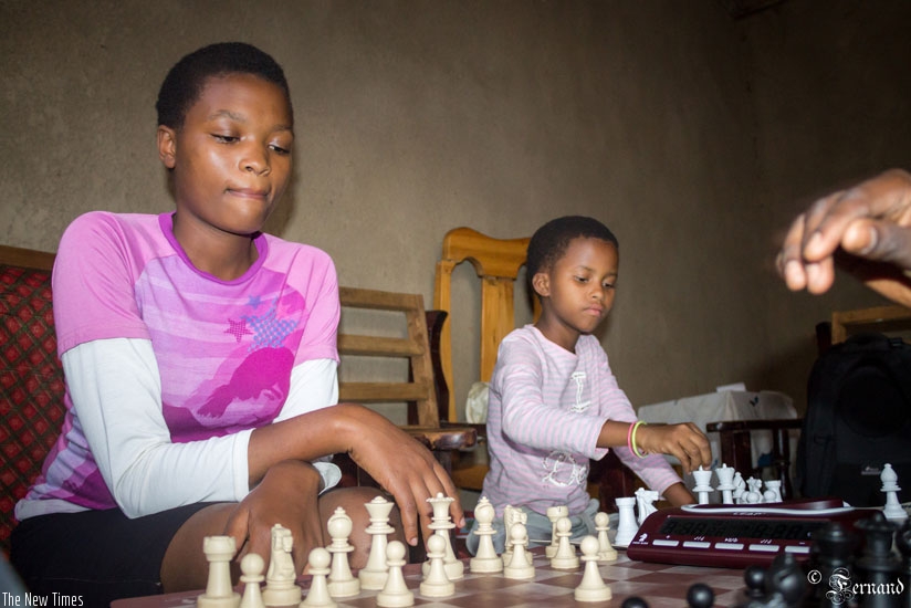 Sandrine Uwase and her Eagles Chess Club colleague Happiness Mutete, 9, play chess at their home in Gikondo, a surbub of City of Kigali. (Courtesy