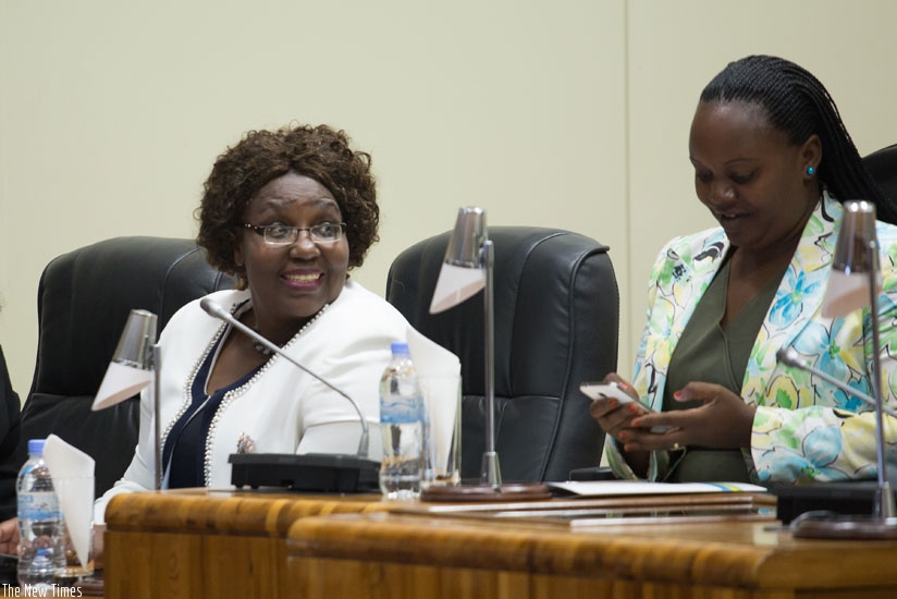 Mukantabana (L) chats with Deputy Speaker of Parliament Jeanne d'Arc Uwimanimpaye at Parliament yesterday. / Timothy Kisambira.