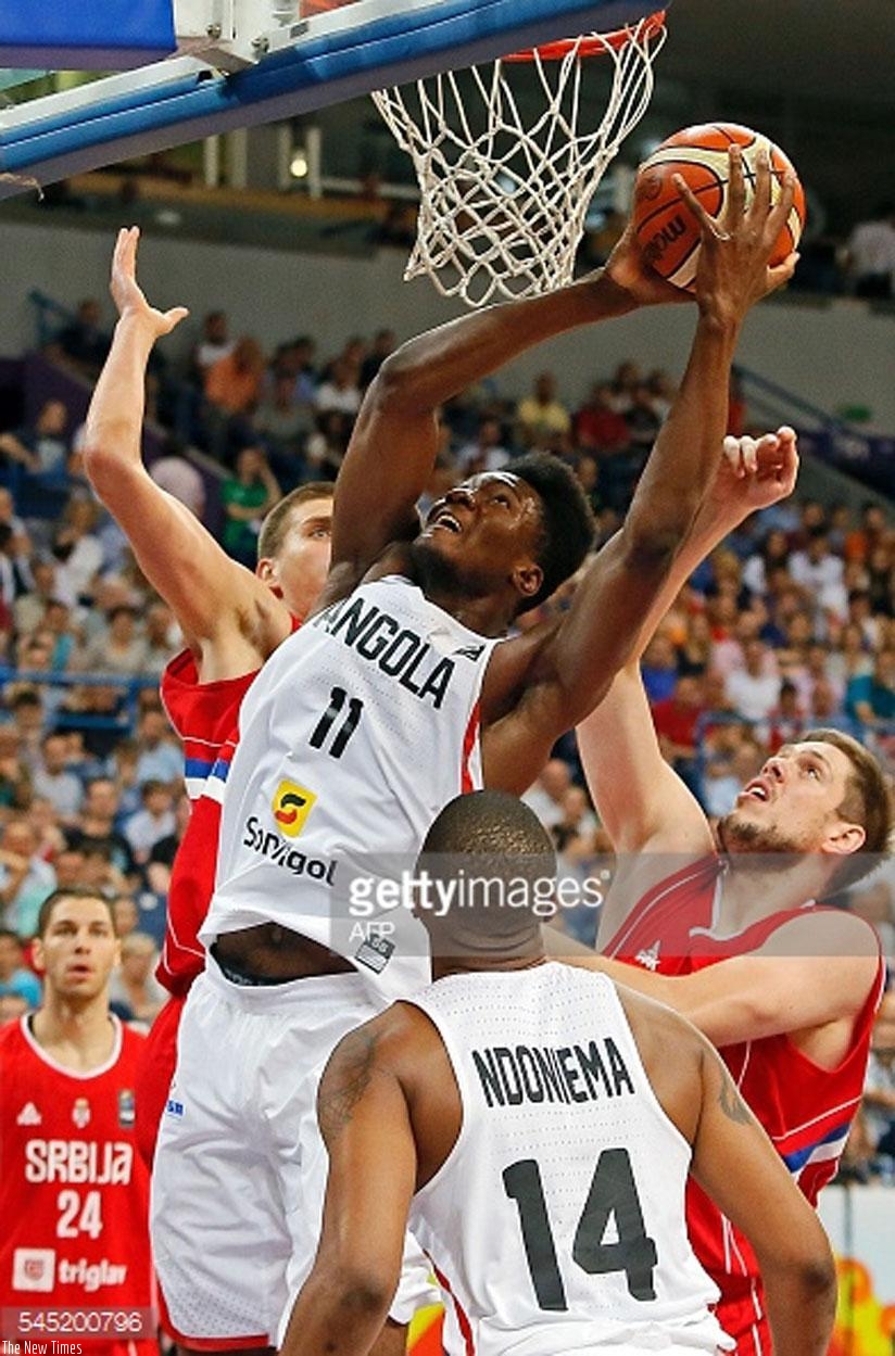 Angolau2019s Bruno Fernandes (C) vies for the ball with Serbiau2019s Vladimir Stimac (R) during the 2016 FIBA World Olympic Qualifying basketball match. (Net photo)