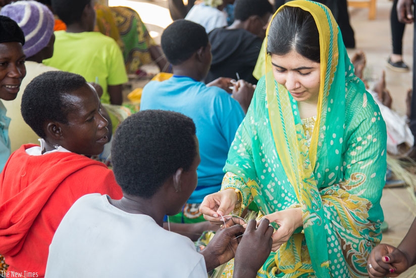 Women at the Mahama camp teach Nobel laureate Malala Yousafzai how to weave peace baskets and handcrafts. / Faustin Niyigena