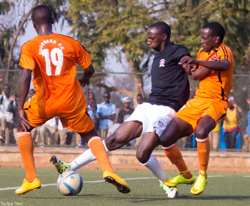 APR midfidler Andrew Buteera tries to beat two Bugesera FC players during the Peace Cup quarter-final clash. / Timothy Kisambira.