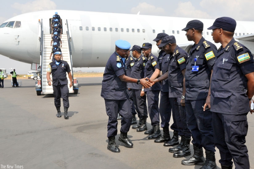 Commissioner of Police Joseph Mugisha greets Rwanda National Police who were receiving the returning contingent of Rwanda National Police UN peacekeepers from Haiti at Kigali Inter....