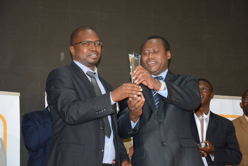 Bigirimana receives his award from Ndagijimana at the event on Friday. (Appolonia Uwanziga.)