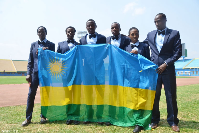 The team that represented Rwanda at the just concluded 2016 IAAF World U-20 Junior Championship in Poland, pose with the national flag before deparure. (Sam Ngendahimana)