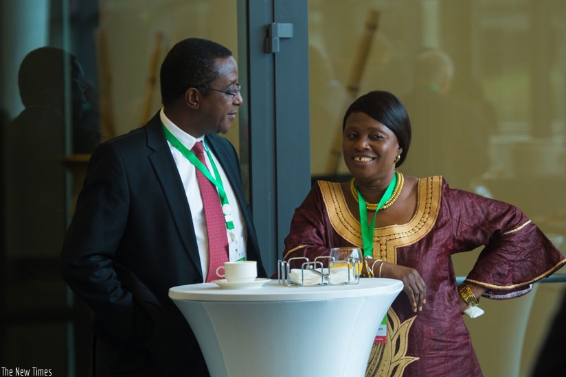 The Minister for Natural Resources, Dr Vincent Biruta (L) chats with Christine Sagno, Guinean minister for environment, water and forests during a breakfast meeting for environment....