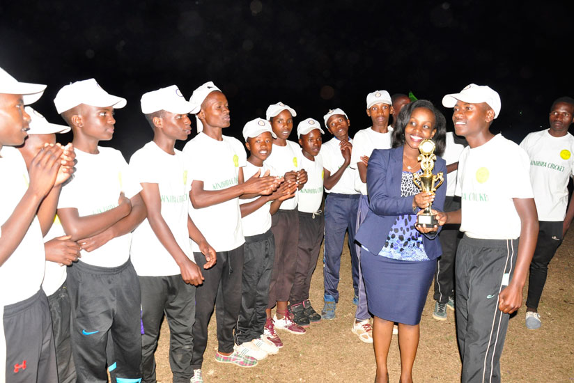 Lycee de Kigali cricket players celebrate with their trophy. / Pontian Kabeera.