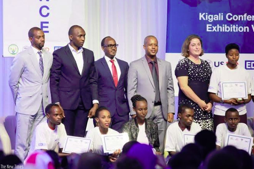 Akazi Kanoze and government officials pose for a photo with some students during the launch in Kigali. (Steven Muvunyi)
