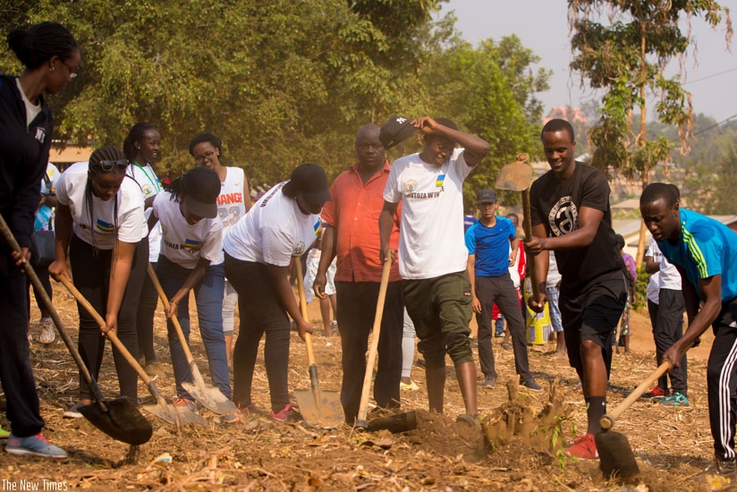 Members of the Rwanda youth forum who include diaspora students take part in Umuganda yesterday at Peace and Hope Initiative nursery school in Kinyinya. / Timothy Kisambira