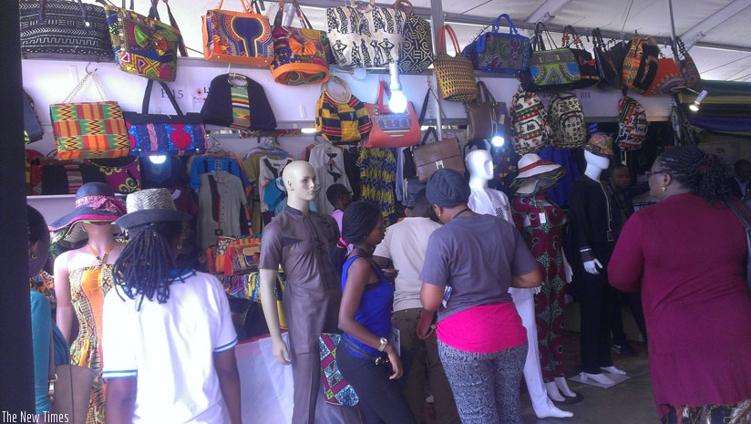 Show goers admire Rwandan made leather handbags at the ongoing expo at Gikondo Show Grounds yesterday. Such can now be exported to the US under AGOA scheme.  (Anitha Kirezi)