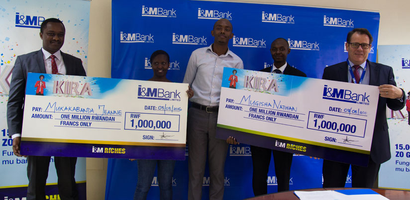 Mukakabanda (second left) and Mugisha (middle) receive dummy cheques from I&M Bank officials led by the banku2019s chief Bairstow (right) and Faustin Byishimo (left), the executive d....
