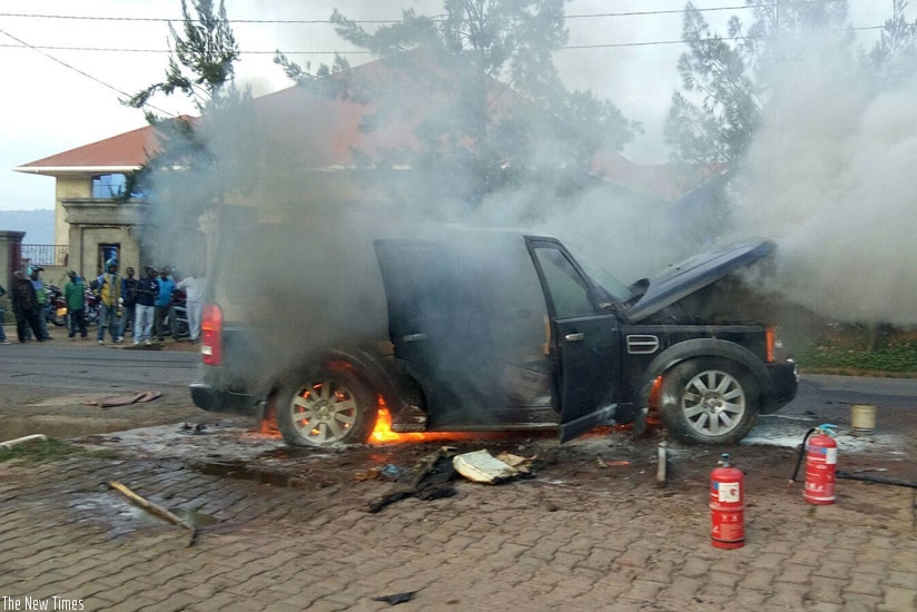 By standers watch as a vehicle burns. Insurance uptake is still low in the region, and in Rwanda, in particular. (File photo)
