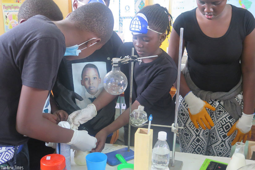Students perform experiments in a laboratory. Part of the reason why tuition fees for science courses have been revised is to cater for the high expenses that come with the these c....