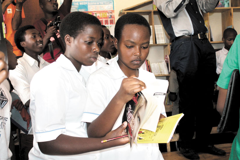 Students peruse through some of book titles at a youth library in Bugesera District. / File.