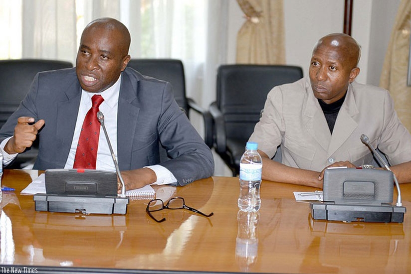 PS Mulindwa addresses the media as Internal Security minister Musa Fazil Harerimana looks on in Kigali yesterday. (Timothy Kisambira.)
