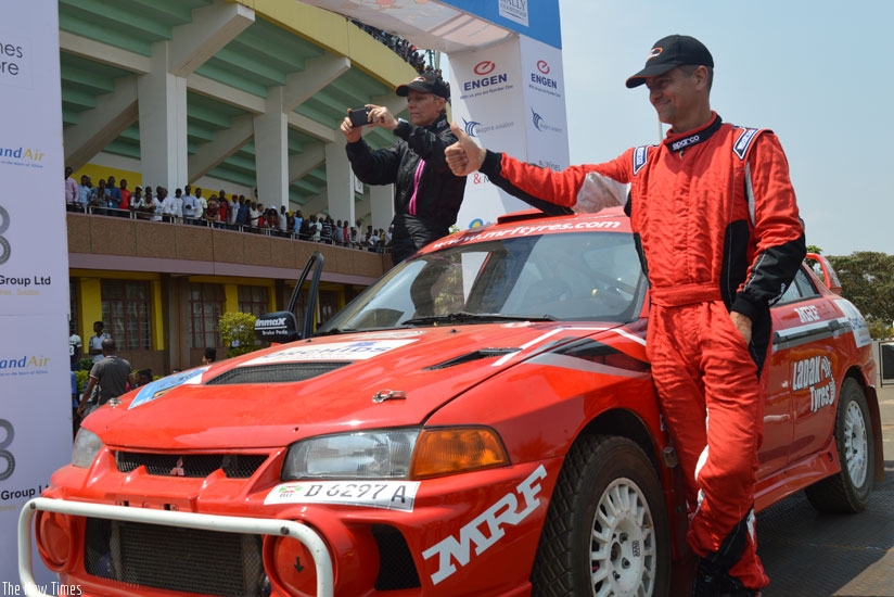 Cantanhede (right) and experienced female navigator, Sylvia Vinevogel pose on their car after yesterday's Super Special Stage at Amahoro Stadium. / Sam Ngendahimana
