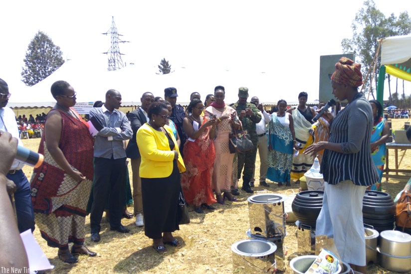 An unidentified woman explains about her environmentally-friendly stoves to local leaders. She was among other women who are helping the communities. / Julius Bizimungu.