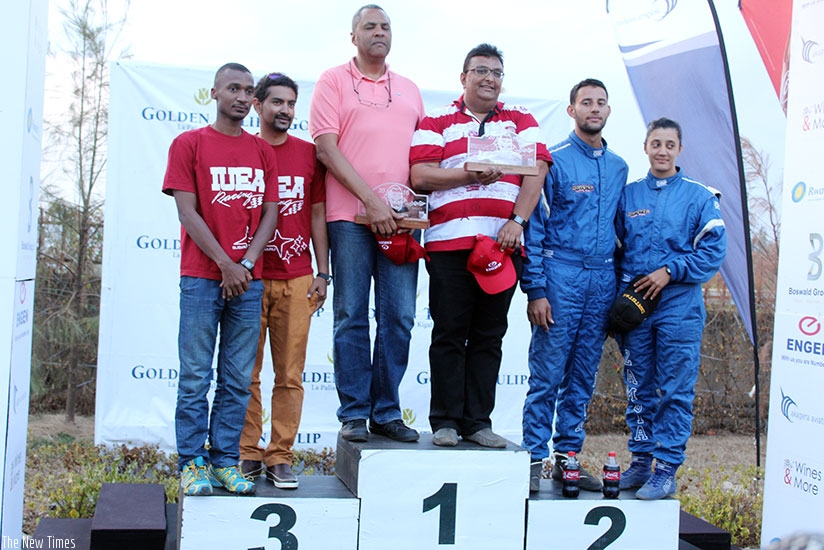 L-R: The top three in the 2016 Rwanda Mount Gorilla Rally, Hassa Alwi, Bukera and Muna Singh Jr., all pose with their navigators on the podium. / Jeje Muhinde.