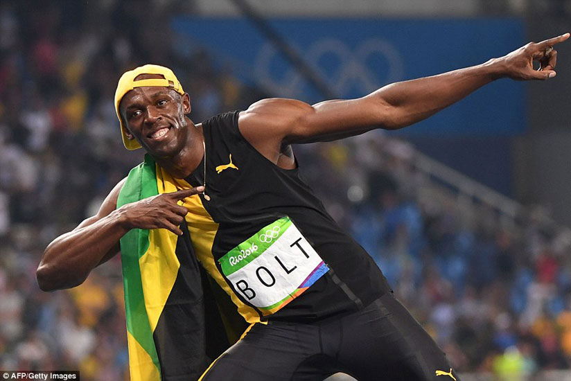 Bolt creates his trademark 'lightning bolt' pose for the cameras as he celebrates yet another Olympic success. / Net photo