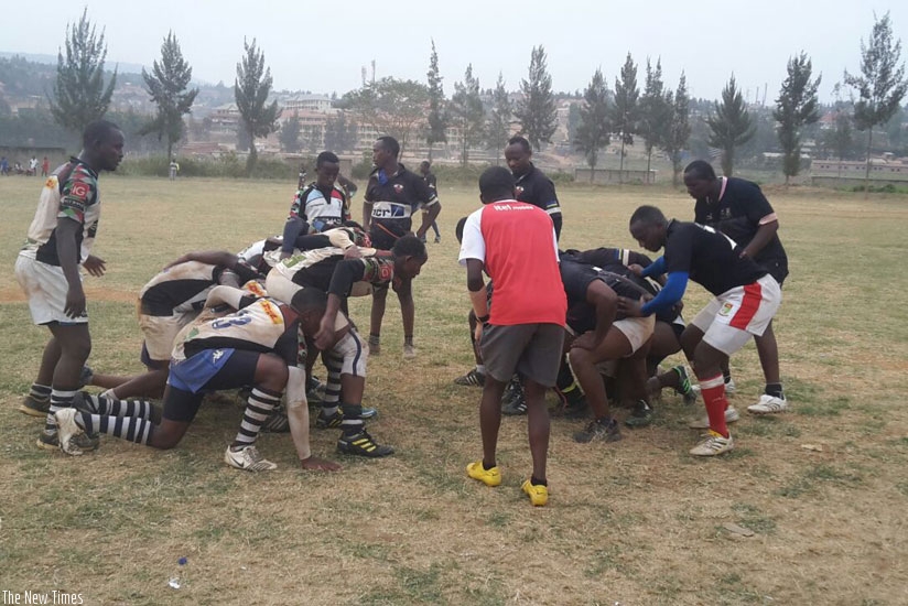 Lion de Fer (black) and Sharks get down for a scrum during the game at the Utexrwa ground on Saturday. (Stephen Kalimba)