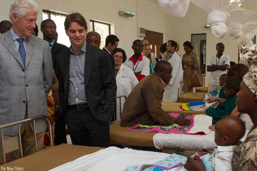Former US President Bill Clinton (L) and other officials visit a hospital ward on a guided tour of Butaro Cancer Centre in Burera District during a previous visit to Rwanda. / File