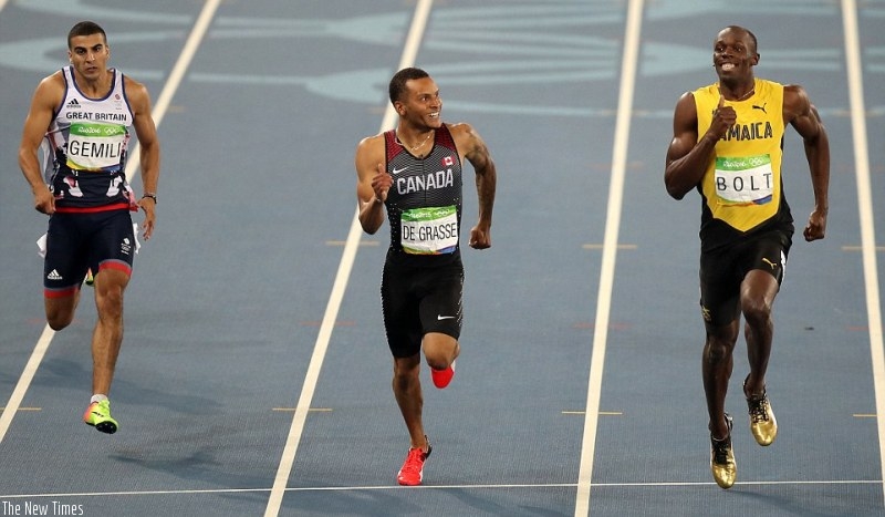 The Jamaican and his Canadian rival share a joke as they crossed the finish line, while Brit Gemili finished third (File photo)