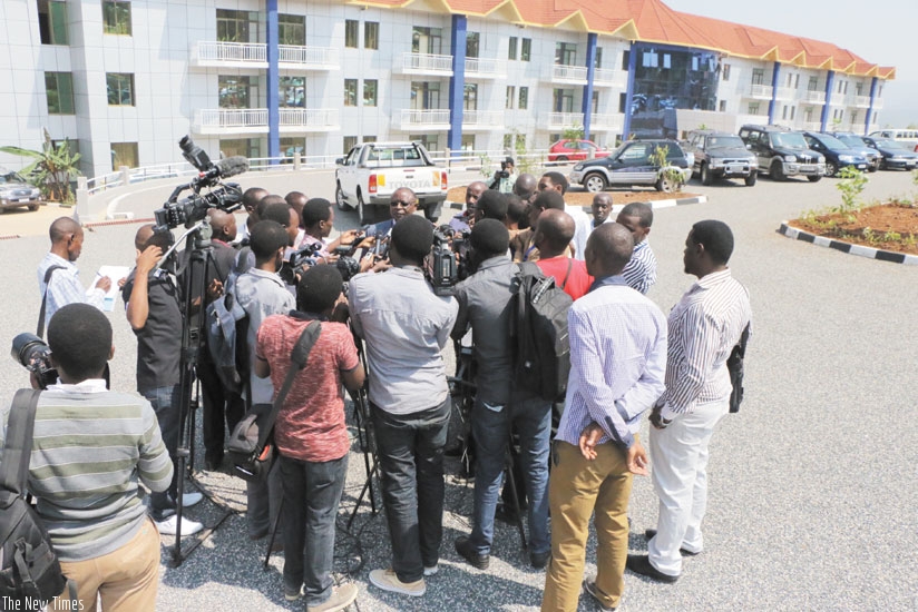 Journalists interview the church's spokesperson. (Julius Bizimungu)