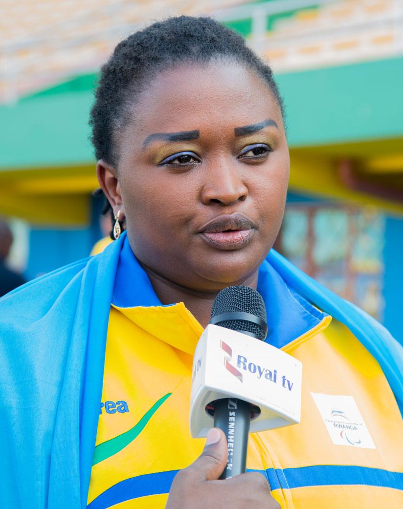 Women sitting volleyball captain, Liliane Mukobwankawe, speaks to the media after receiving the national flag last Wednesday. / Faustin Niyigena.