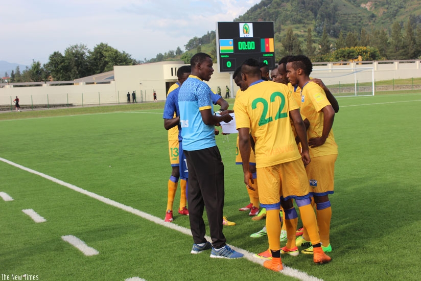 Jimmy Mulisa (left) issues instructions to Amavubi players during a friendly match against Cameroon early this year. / File.