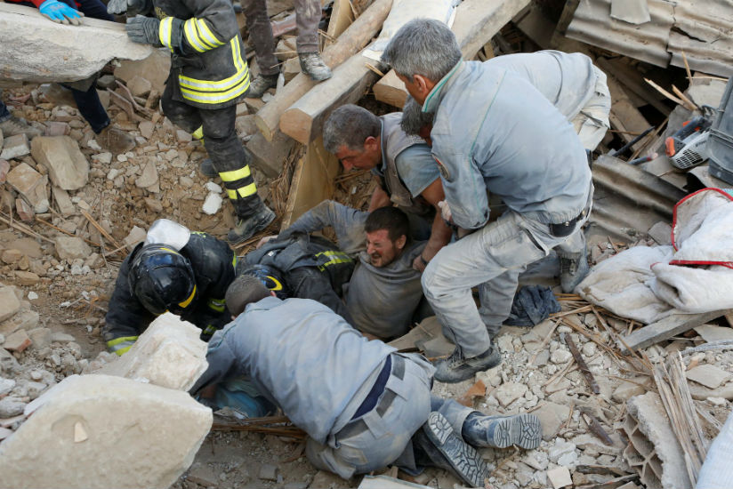 A man is rescued alive from the ruins.rnPhotograph: Remo Casilli/Reuters