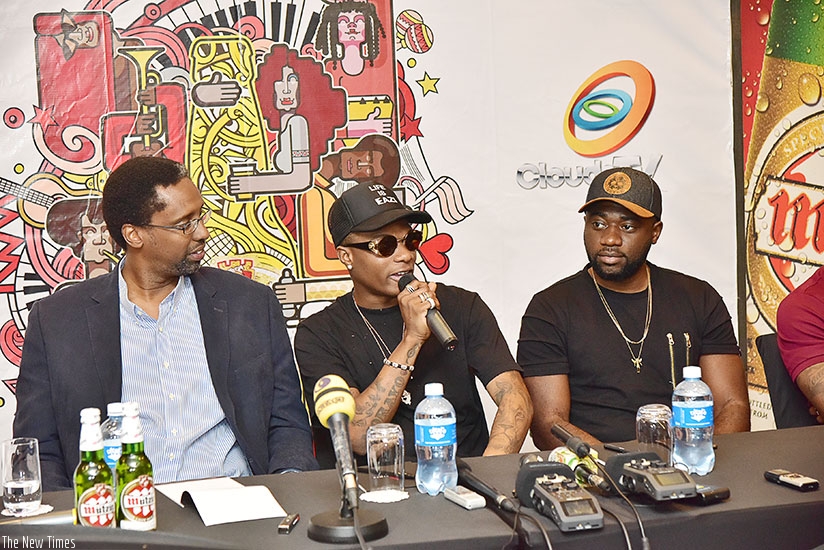Wizkid (C) speaks during the press conference as Julius Kayoboke, marketing director, Bralirwa (L) looks on. / Nadege Imbabazi.