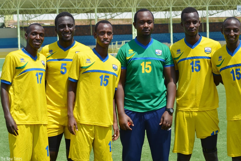 Newly appointed Amavubi interim assistant coach Mashami and some players take a break from training to pose for the cameras at Kigali Regional Stadium last week. / Sam Ngendahimana.