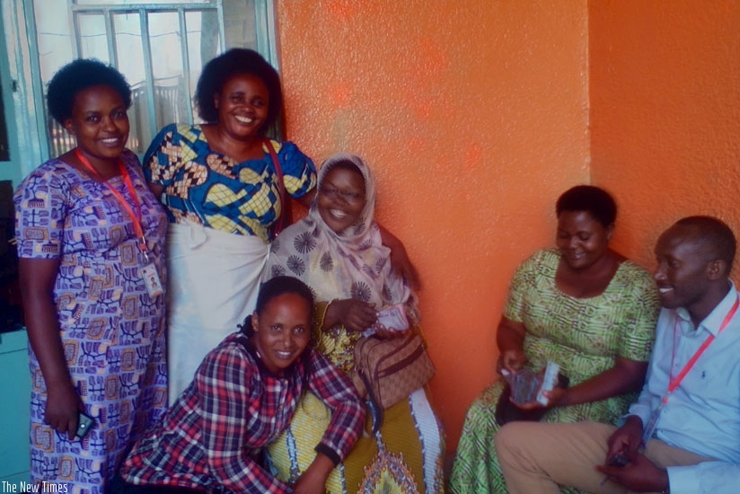 Kayonde (right) and other co-op members at their offices in Nyabugogo. The group is looking to start carrot processing in the near future. (Elias Hakizimana.)