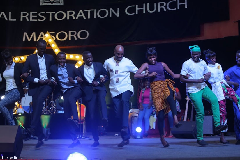 Apostle Joshua Masasu (C) joins the artistes on stage. (All photos by Donata Kiiza.)