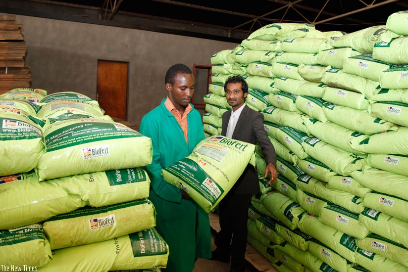 A worker carries a bag of fertilisers in one of the stores in Gikondo. / File.