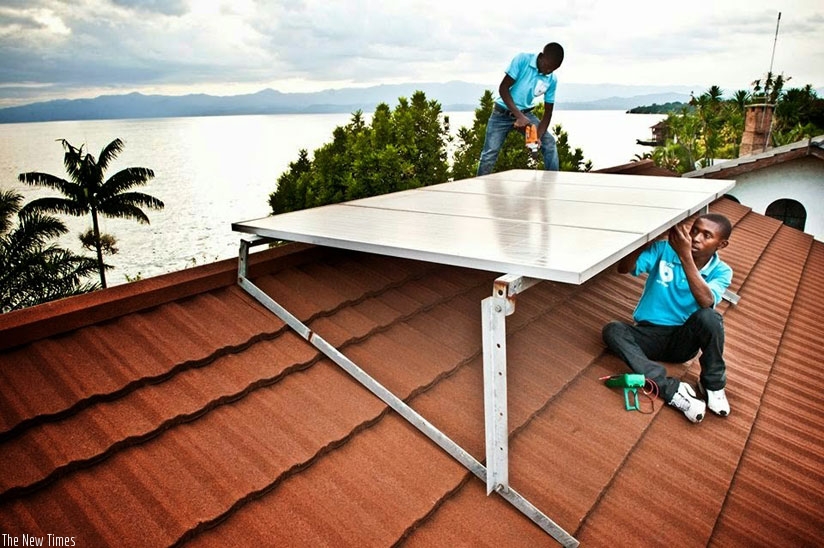 BBOXX Rwanda staff fix a solar panel for a client. 