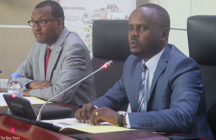Nsanganira addresses partners in agriculture in Kigali as Parfait Busabizwa, the vice mayor in charge of finance and economic development at the City of Kigali, looks on. 