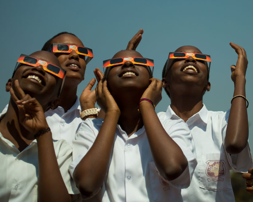 Students of St Paul International School view the major celestial event, the solar eclipse, from University of Rwanda's College of Education main campus in Kigali yesterday. (Photo....