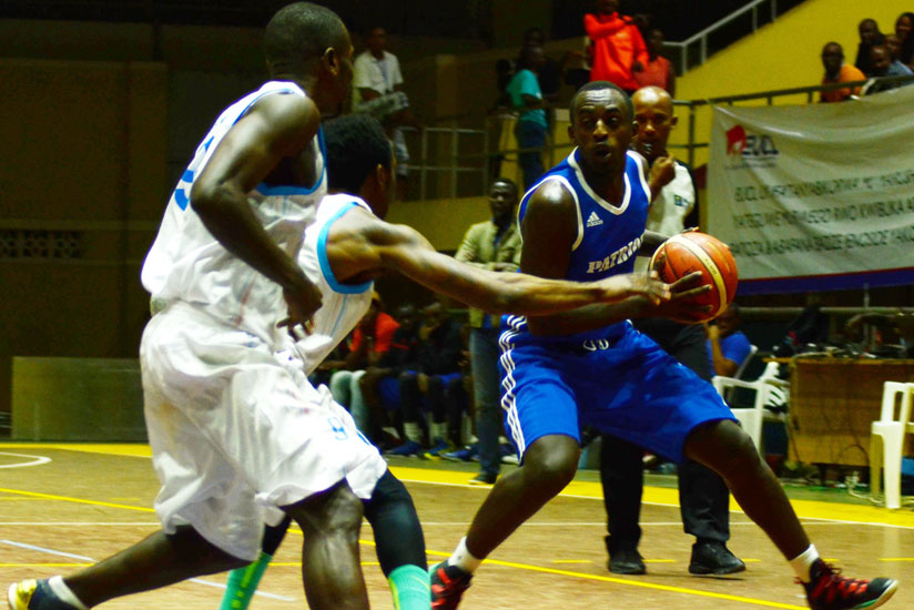 Aristide Mugabe of Patriots (R) attempts to make a pass during this year's Gisembe memorial tourney. The league winners are preparing for Zone V. / Sam Ngendahimana.
