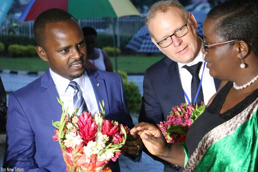 Agriculture state minister Tony Nsanganira (left) and a guest listen to Christine Murebwayire, the Association of Rwanda Farmers chairperson and the Chamber of Agriculture head, du....