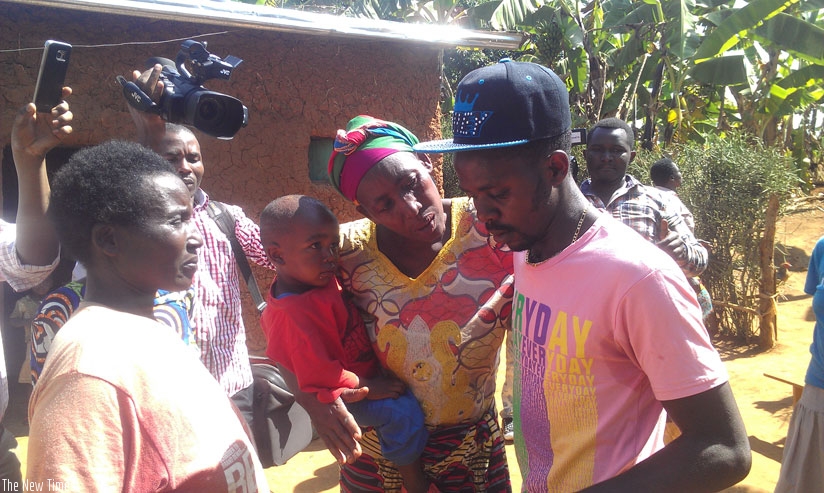 Ngendahimana is consoled by his mother (2nd R) as he arrives at home. (Frederic Byumvuhore)