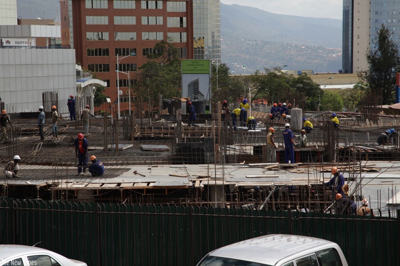 Workers at a construction site in Kigali. (Timothy Kisambira)