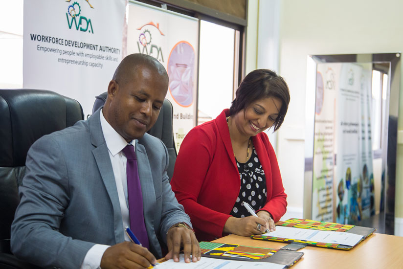 Jerome Gasana, the director general of WDA, and Dr Priya Ramluggun-Essoo, head of Business Development of Rushmore, sign the MoU on Wednesday in Kigali. (Faustin Niyigena)
