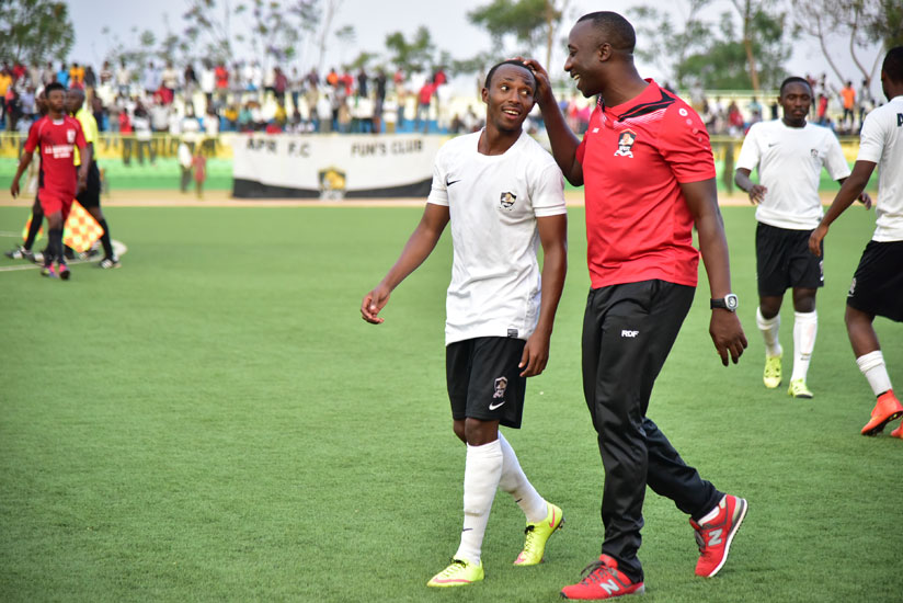 Maxime Sekamana is congratulated by goalkeeping coach Ibrahim Mugisha. / Peter Kamasa.