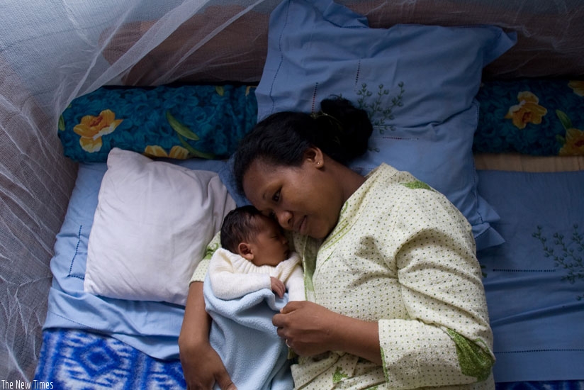 A woman with her baby sleep in a mosquito net. Experts have warned that Sub-Saharan Africa is likely to see a surge in malaria cases due to climate change. / File